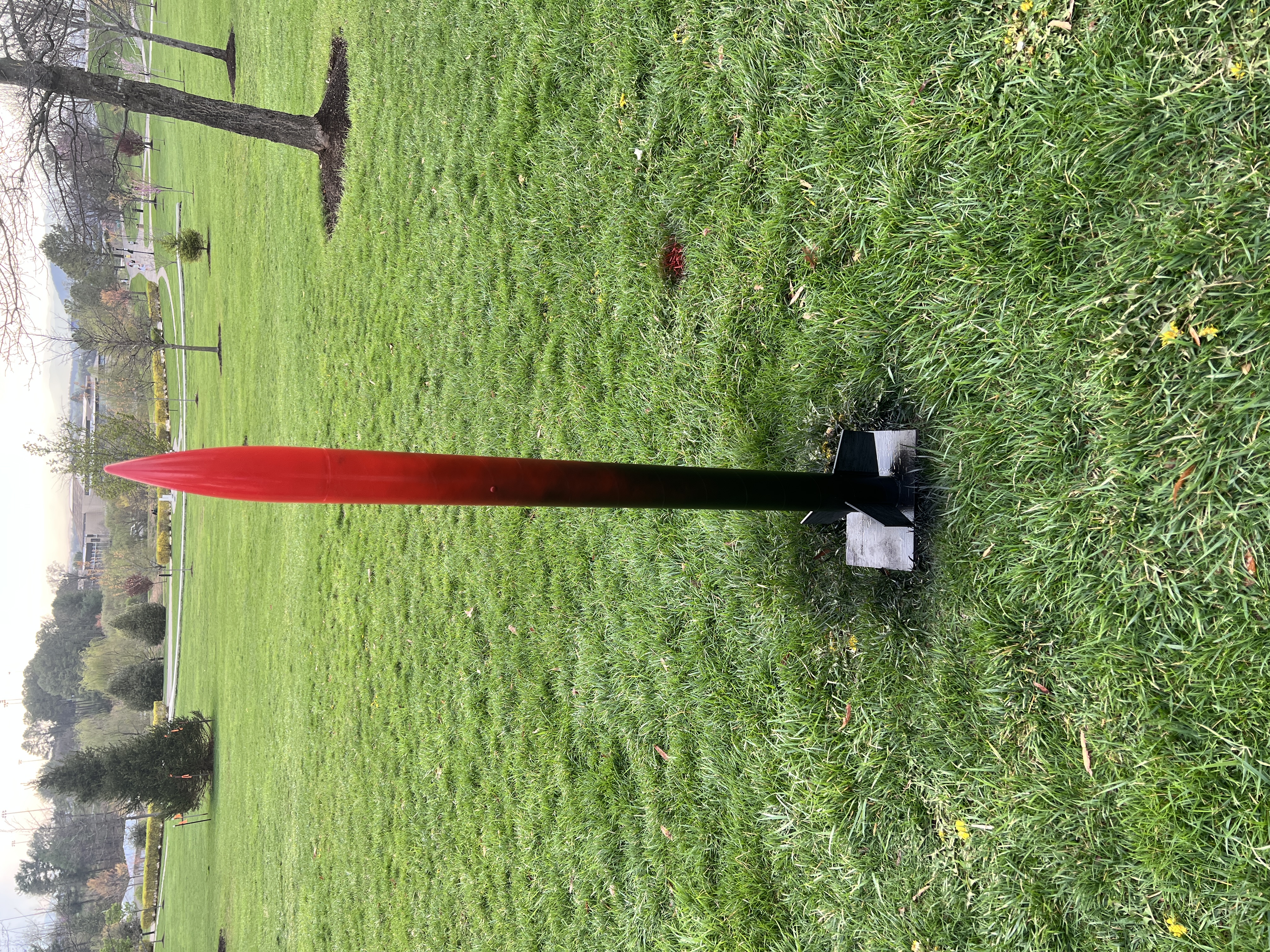 Finished rocket with matte black body and gloss red nose cone